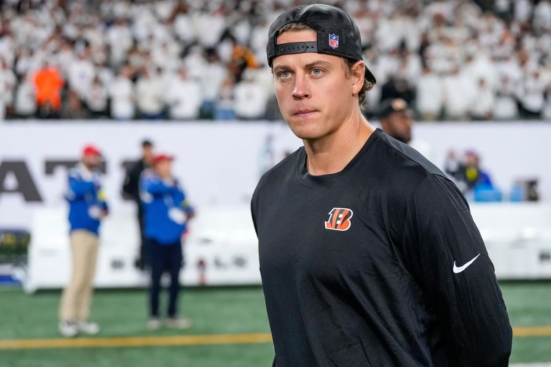 Injured Cincinnati Bengals quarterback Joe Burrow (9) walks on the field after the fourth quarter of the NFL Week 7 game between the Cincinnati Bengals and the Pittsburgh Steelers at Paycor Stadium in downtown Cincinnati on Thursday, Oct. 16, 2025. The Bengals won, 33-31.