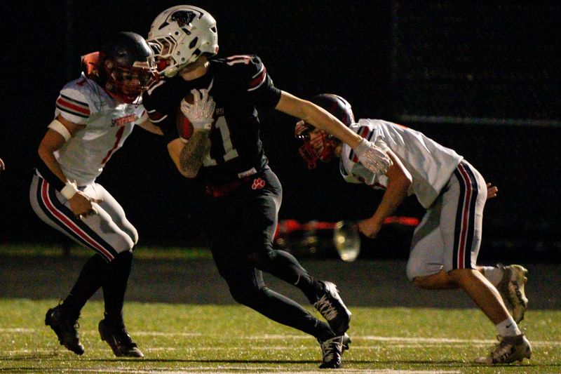 Norton’s Buddy Willig (11) evades Springfield defensive efforts in the first quarter, Oct. 17, 2025, at Norton High School in Norton, Ohio.
