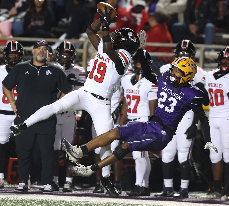 McKinley's Darius Hill makes a leaping catch on a 38-yard play as Jackson’s Jackson Baker defends in the second half, Friday, Oct. 17, 2025.