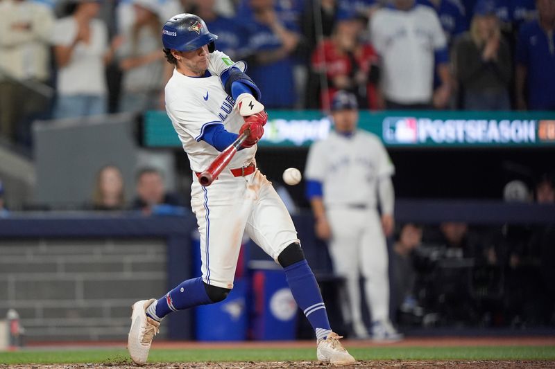 Toronto Blue Jays third baseman Ernie Clement hits a single against the Seattle Mariners in the eighth inning during game seven of the ALCS round for the 2025 MLB playoffs at Rogers Centre.