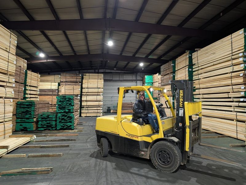 A Brenneman Lumber Company employee in Mount Vernon, Ohio pulls packs of lumber from a warehouse to ready them for shipping. The hardwood industry has struggled under the Trump administration's trade war.