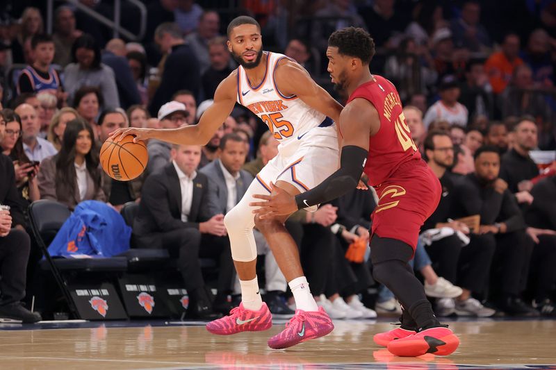 Oct 22, 2025; New York, New York, USA; New York Knicks guard Mikal Bridges (25) controls the ball against Cleveland Cavaliers guard Donovan Mitchell (45) during the first quarter at Madison Square Garden. Mandatory Credit: Brad Penner-Imagn Images