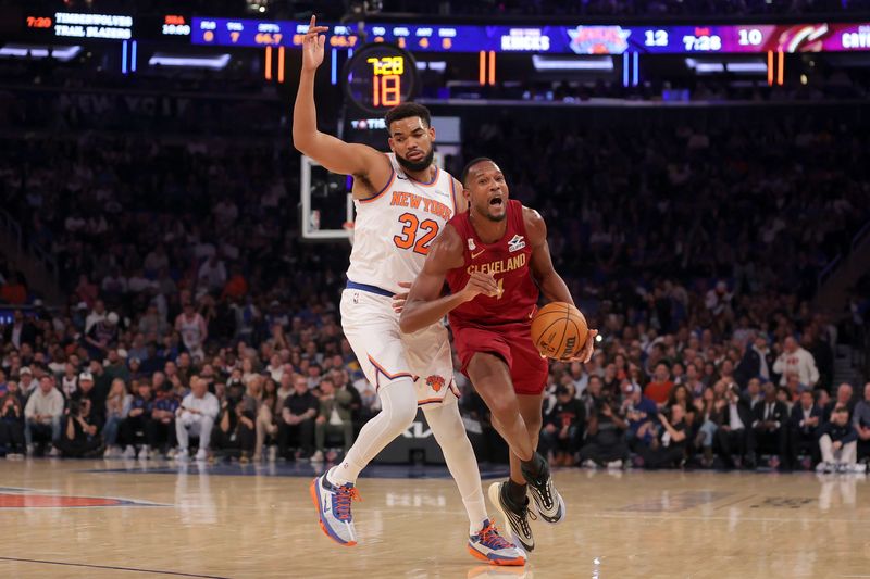New York Knicks center Karl-Anthony Towns (32) fouls Cleveland Cavaliers center Evan Mobley (4) on Oct. 22, 2025, in New York, New York.