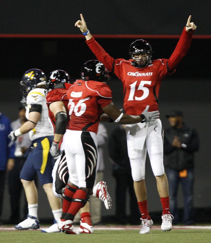 Tony Pike raises his hands in triumph for the Cincinnati Bearcats. Pike led UC to the Orange and Sugar bowls in back-to-back seasons.