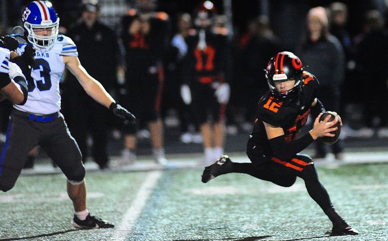 Green's Tyson Hunka cuts to escape Lake's pass rush Friday October 24, 2025. Michael Skolosh/Special to the Canton Repository
