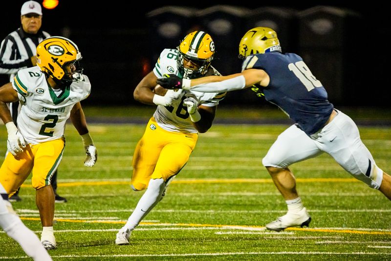 St. Edward's Tyrese Buchanan (26) is brought down by Hoban’s Brayton Feister (18), right, Oct. 24, 2025, at Dowed Field in Akron, Ohio.