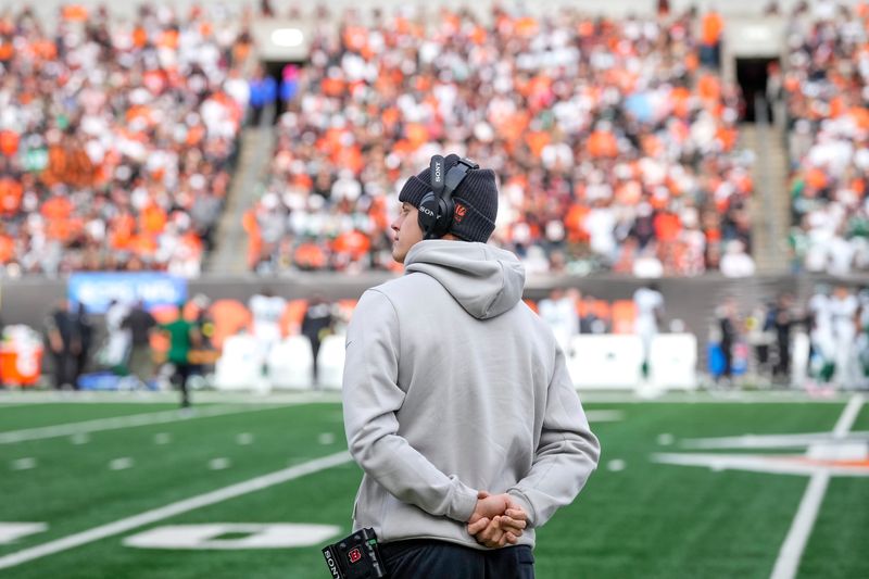 Injured Cincinnati Bengals quarterback Joe Burrow looks on from the sideline