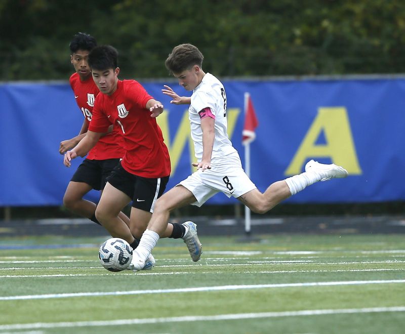 Moeller senior Karson Lang (8) passes the ball as Lakota West defeated Moeller 2-1 in an OHSAA boys soccer Division I district final Oct. 25, 2025 at Mariemont's Kusel Stadium.