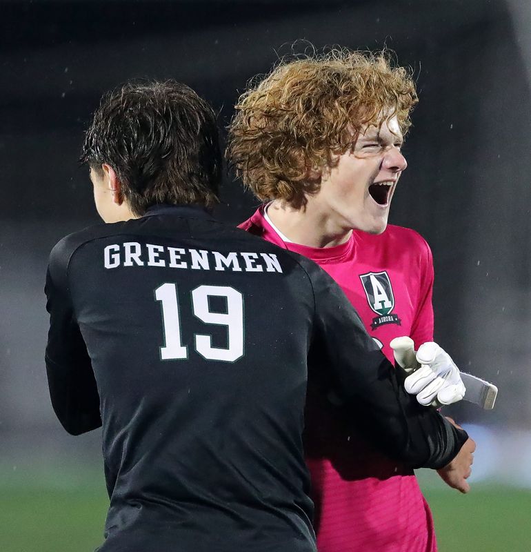Aurora goalkeeper Bryce Peckinpaugh, facing, celebrates with Nicholas Savukas after beating Canfield in a Division III regional semifinal soccer game, Oct. 29, 2025, in Twinsburg, Ohio