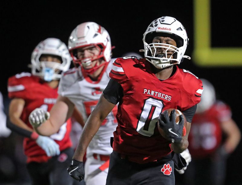Norton running back Marcus Brown, right, breaks away for a big run during the first half of a Division III first round playoff football game, Oct. 31, 2025, in Norton, Ohio