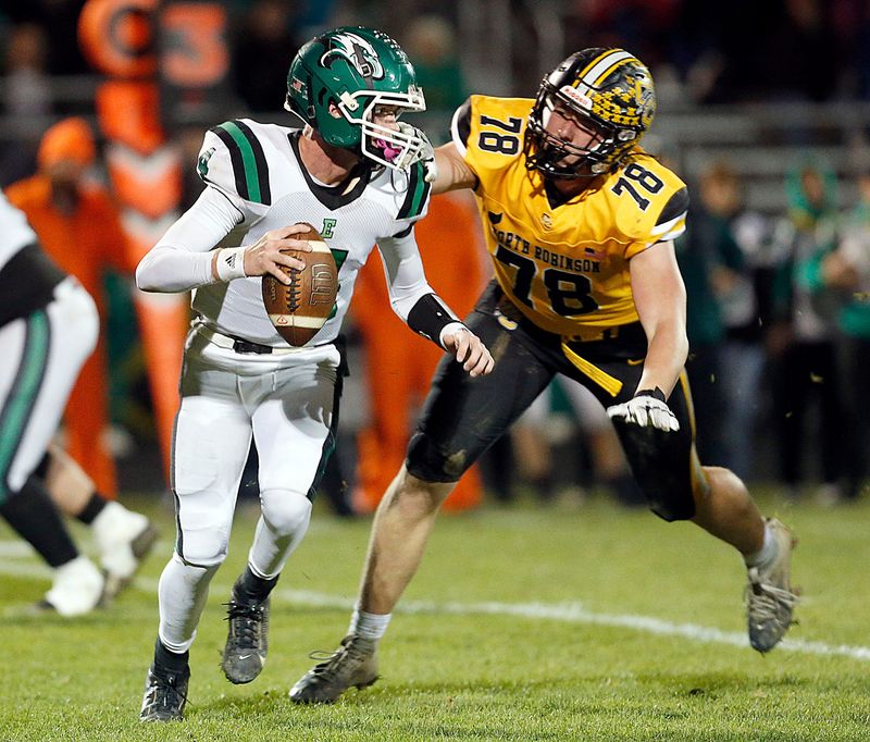 Colonel Crawford High School's Payne DeGray (78) pressures Reedsville Eastern High School's quarterback Braxton Yonker (4) during OHSAA Division VI regionals first round high school football action Friday, Oct. 31, 2025 at Colonel Crawford High School.