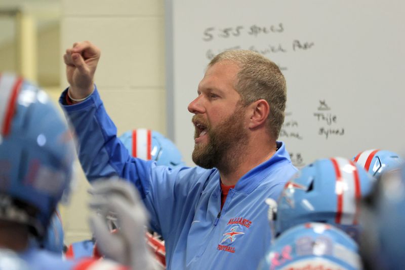 Alliance football coach Tim Goodman talks to his team in the locker room ahead of the program's first-ever home playoff game, as the Aviators hosted Geneva in a first-round game at Kehres Stadium, Friday, Oct. 31, 2025.