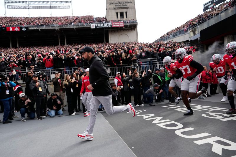 Ohio State Buckeyes head coach Ryan Day leads his team on the field for the NCAA football game against the Penn State Nittany Lions at Ohio Stadium in Columbus on Nov. 1, 2025.