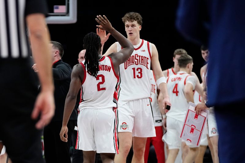 Ohio State Buckeyes center Christoph Tilly (13) high fives guard Bruce Thornton (2) during the NCAA men's basketball game against the IU Indy Jaguars at Value City Arena in Columbus on Nov. 3, 2025. Ohio State won the season opener 118-102.