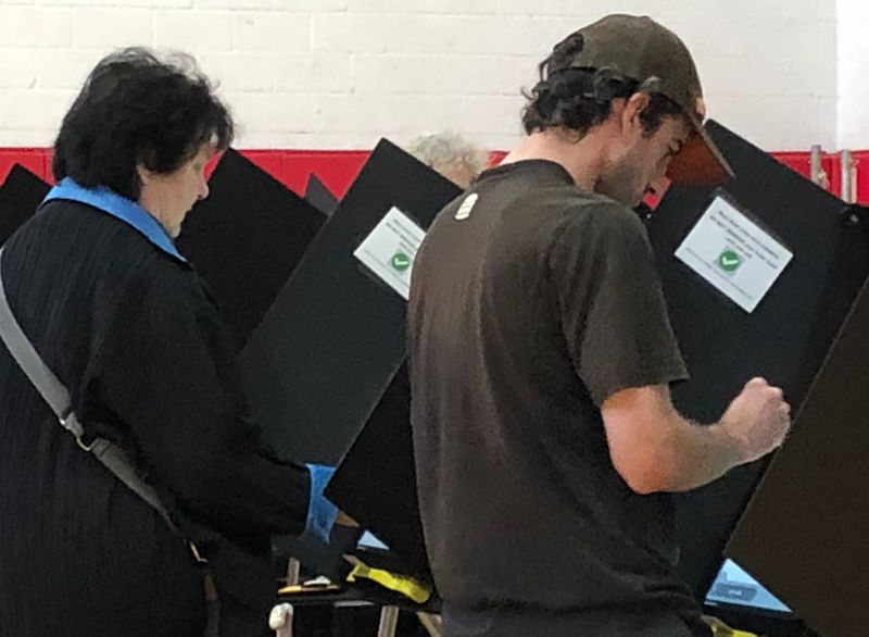 A steady stream of lunchtime voters cast ballots on Nov. 4, 2025, in the gymnasium at Alliance High School.