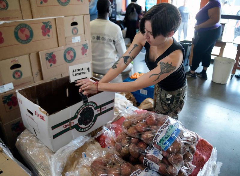 Sabrina Custer helps get bags of potatoes ready at All People's Fresh Market on Parsons Avenue in Columbus on Nov. 5, 2025. The food pantry distributed more than 7,000 pounds of food to between 300 and 400 people that day.