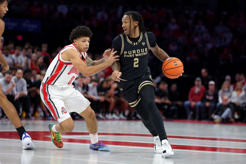 Nov 7, 2025; Columbus, Ohio, USA; Purdue Fort Wayne Mastodons guard Mikale Stevenson (2) controls the ball as Ohio State Buckeyes guard John Mobley Jr. (0) defends during the first half at Value City Arena. Mandatory Credit: Joseph Maiorana-Imagn Images