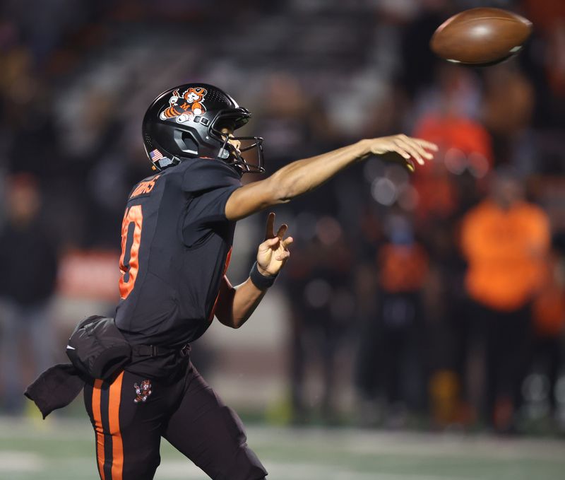 Massillon's Manny Patterson throws a pass against Hoover in an OHSAA football Region 7 quarterfinal at Paul Brown Tiger Stadium Friday, Nov. 7, 2025.