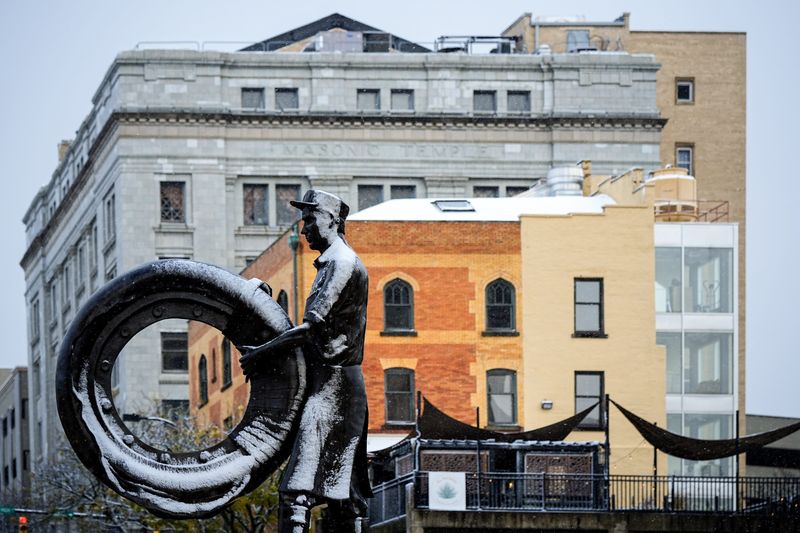 The Rubber Worker Statue crafted by Zanesville’s Alan Cottrill is seen partially covered in snow during the first snowfall of the season in Akron, Ohio, Nov. 10, 2025.