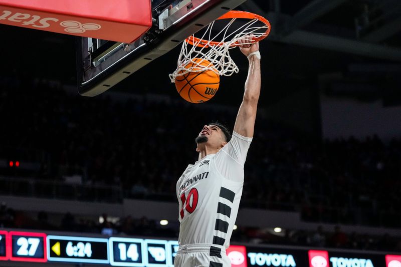 Cincinnati Bearcats guard Shon Abaev (10) dunks against the Dayton Flyers Nov. 11, 2025 at Fifth Third Arena.