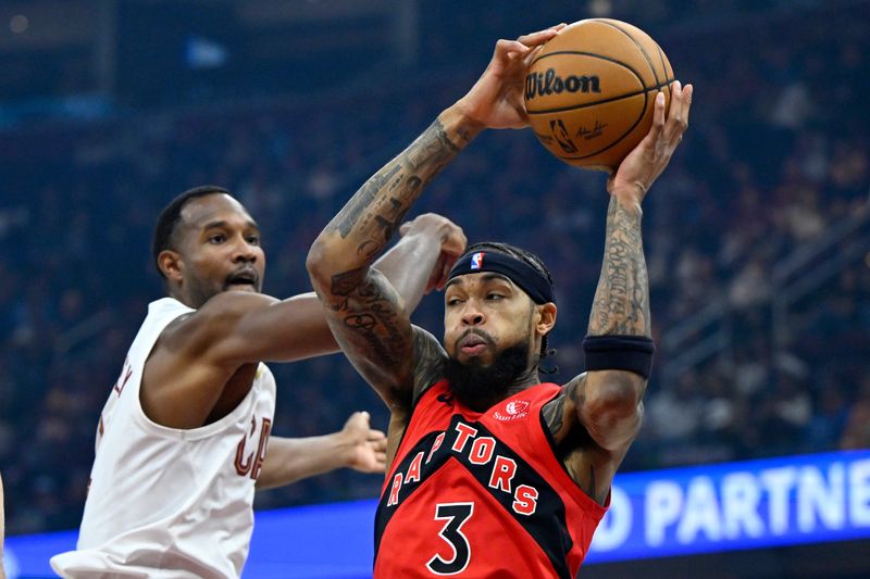 Toronto Raptors forward Brandon Ingram (3) rebounds as Cleveland Cavaliers center Evan Mobley swats at the ball Nov. 13, 2025, in Cleveland.