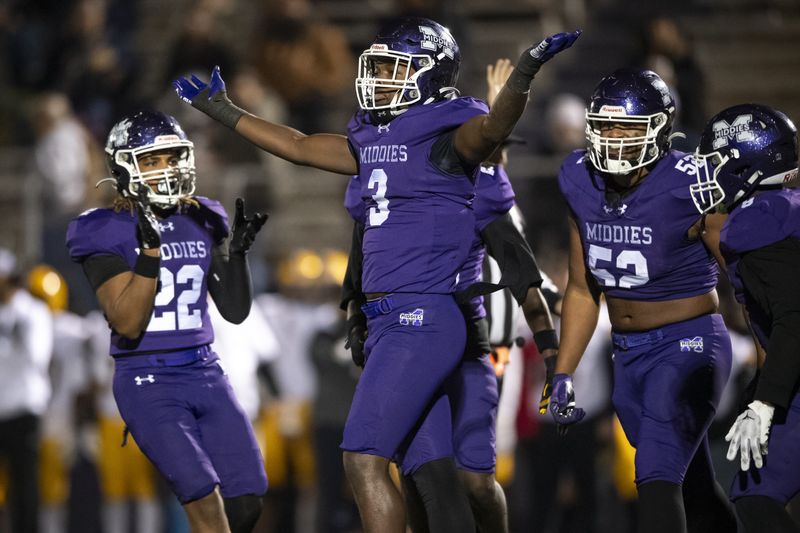 Middletown DL J.D. Singletary (3) celebrates with teammates after making a stop against Springfield in the first quarter during the OHSAA Division I regional semifinal game between Middletown and Springfield Friday, Nov. 14, 2025, at Middletown.