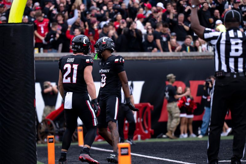 Cincinnati Bearcats wide receiver Jeff Caldwell (9) reacts with Cincinnati Bearcats tight end Patrick Gurd (21) after he scored a touchdown last Nov. 15 vs. Arizona at Nippert Stadium.