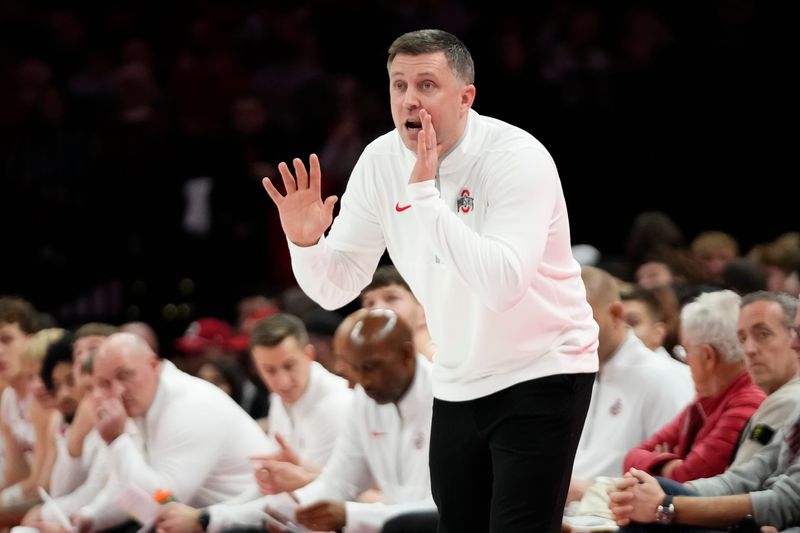 Ohio State Buckeyes head coach Jake Diebler motions to his team during the first half of the men's NCAA basketball game against the Notre Dame Fighting Irish at Value City Arena in Columbus on Nov. 16, 2025.