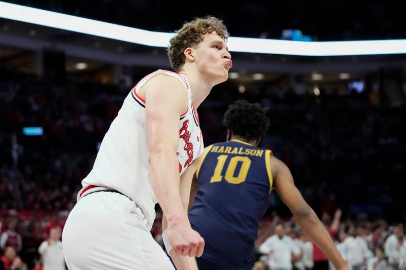 Ohio State Buckeyes center Christoph Tilly (13) celebrates after hitting the game-winning shot over Notre Dame Fighting Irish forward Carson Towt (33) and forward Garrett Sundra (12) during the men's NCAA basketball game at Value City Arena in Columbus on Nov. 16, 2025. Ohio State won 64-63.