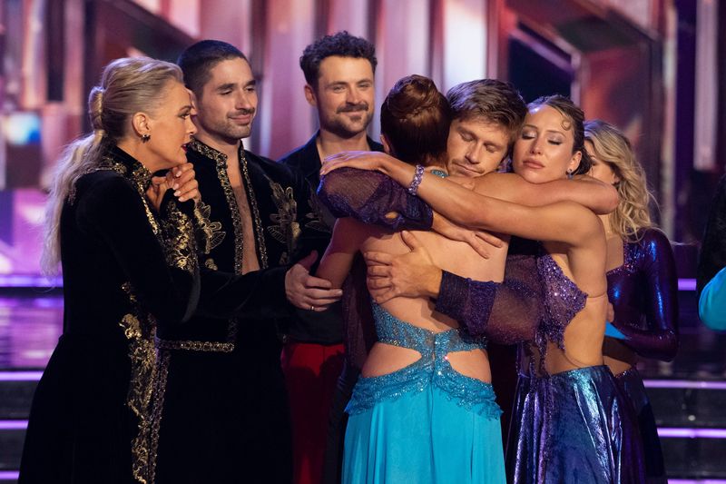 Elaine Hendrix, Alan Bersten, Dylan Efron, Robert Irwin, Alix Earle and Witney Carson say goodbye to contestant Whitney Leavitt after her elimination on "Dancing With the Stars" on Tuesday, Nov. 18, 2025.