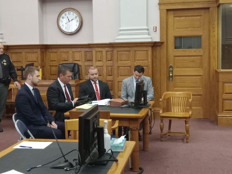 Canton police officer Beau Schoenegge, defense attorney Donald Malarcik, Canton police Officer Camden Burch and defense attorney Jacob Will, left to right, wait for a hearing to begin in Stark County Common Pleas Court on Nov. 19.