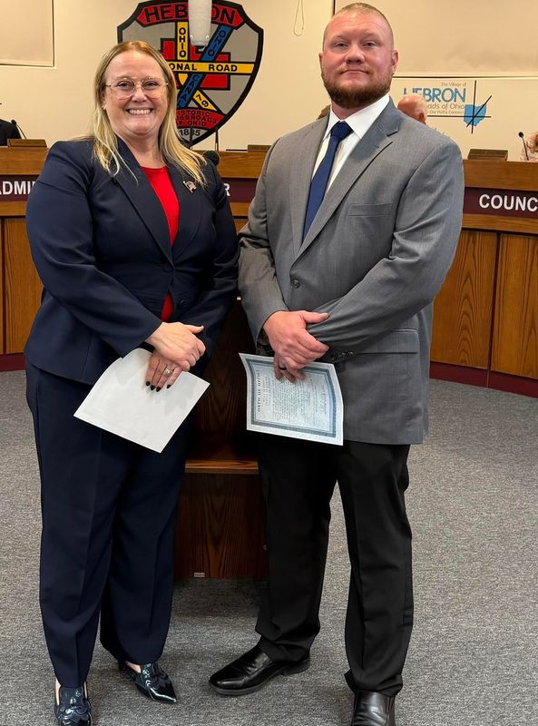 Hebron Mayor Valerie Mockus stands next to the village's new police chief, Tyler Welsh.
