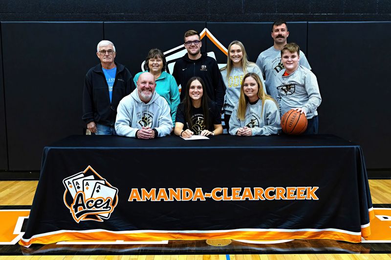 Amanda-Clearcreek senior Taylor Evans, while being surrounded by her family, signed her letter of intent to further her education and play basketball at Ohio Dominican University.