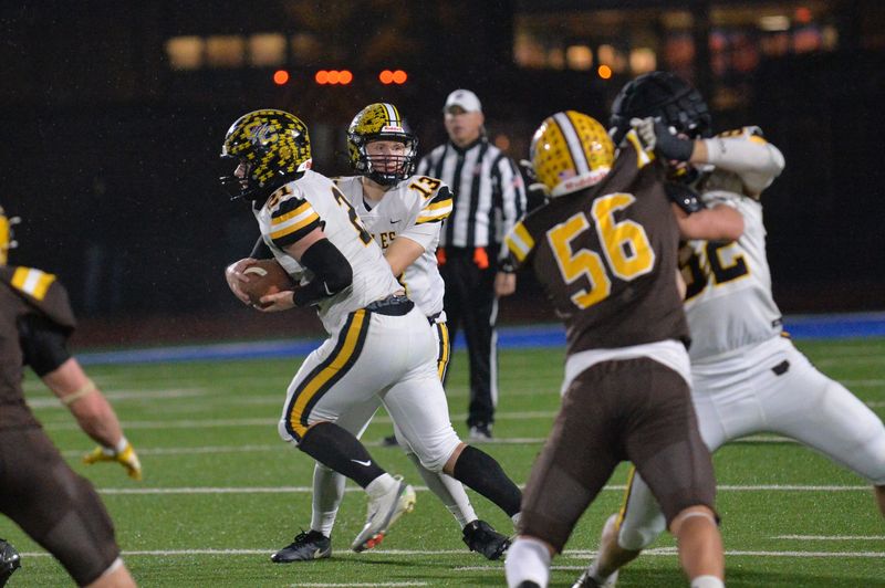 Colonel Crawford's Brayden Holt hands off to Connor McMichael.