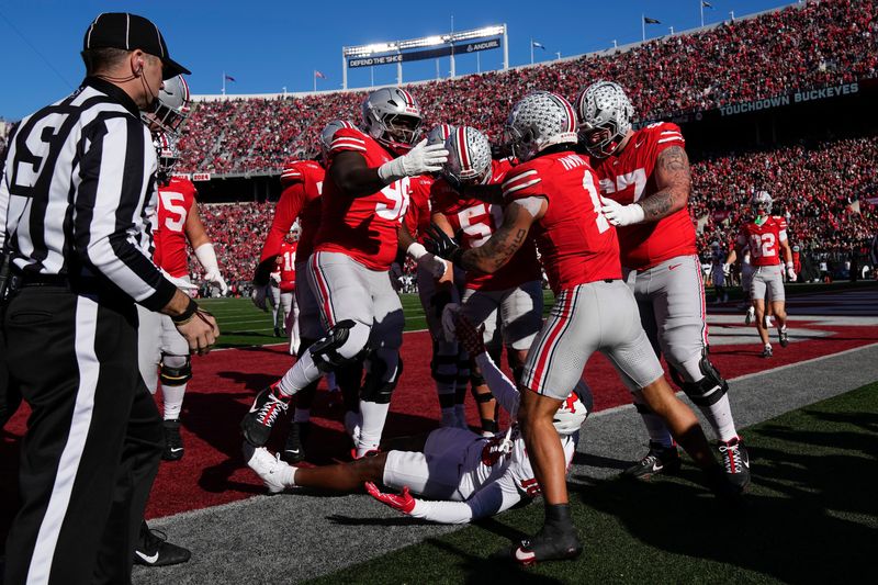 Teammates celebrate a touchdown by Ohio State Buckeyes wide receiver Brandon Inniss (1) during the first half of the NCAA football game against the Rutgers Scarlet Knights at Ohio Stadium in Columbus on Nov. 22, 2025.