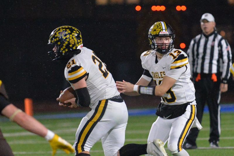 Colonel Crawford's Brayden Holt hands off to Connor McMichael.