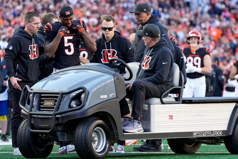 Cincinnati Bengals wide receiver Tee Higgins (5) is carted off of the field