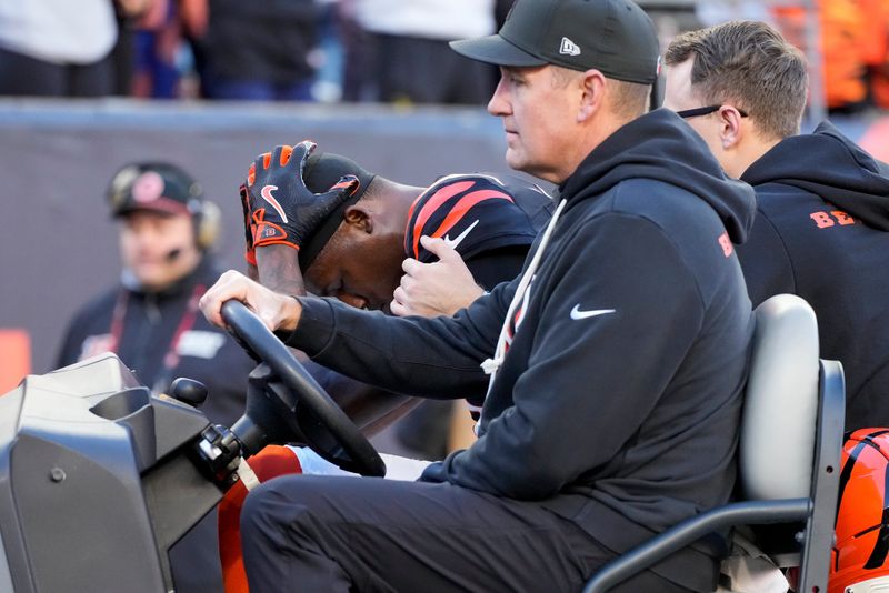 Cincinnati Bengals wide receiver Tee Higgins (5) is carted off of the field after suffering a concussion on a play in the fourth quarter of the NFL Week 12 game between the Cincinnati Bengals and the New England Patriots at Paycor Stadium in downtown Cincinnati on Sunday, Nov. 23, 2025. The Bengals fall to 3-8 with a 26-20 loss at home.
