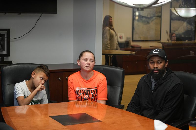 Eden Castleberry, at center, her 9-year-old son and his father Will J Castleberry, sit for an interview at the Downtown offices of Thompson Legal.
