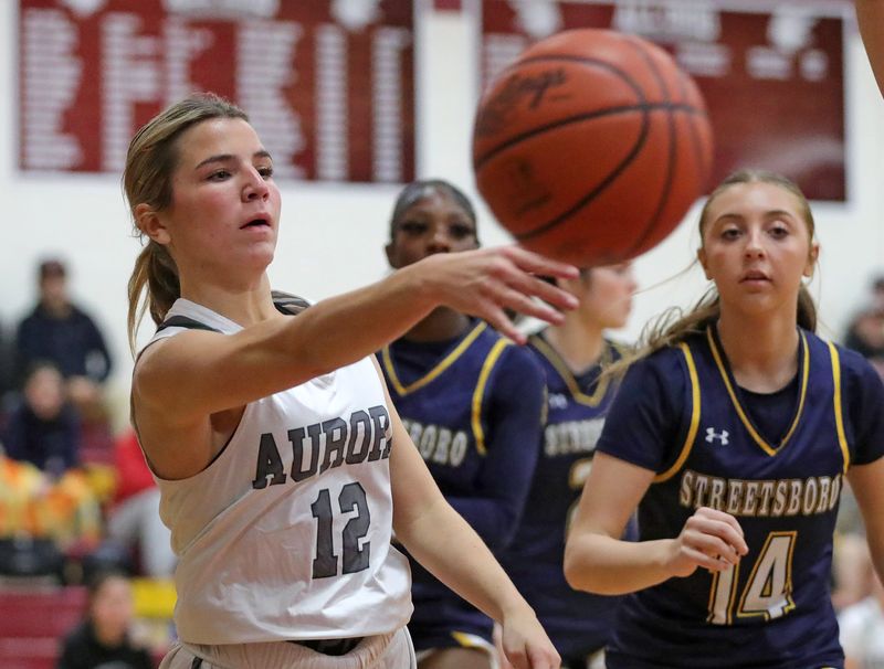 Aurora’s Brooke Pierce, left, makes a pass ahead of Streetsboro’s Ava Scisciani during the Portage Sports high school girls basketball preview, Nov. 6, 2025, in Atwater, Ohio