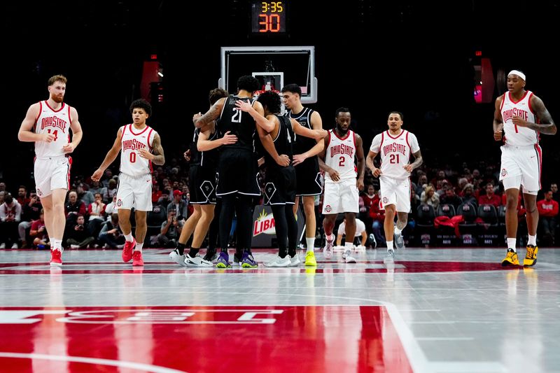 Ohio State Buckeyes forward Brandon Noel (14), guard John Mobley Jr. (0), guard Bruce Thornton (2), forward Devin Royal (21) and forward Amare Bynum (1) walk to the other side of the court against the Mount St. Mary's Mountaineers in the first half of the NCAA basketball game at Value City Arena on Tuesday, Nov. 25, 2025 in Columbus, Ohio.