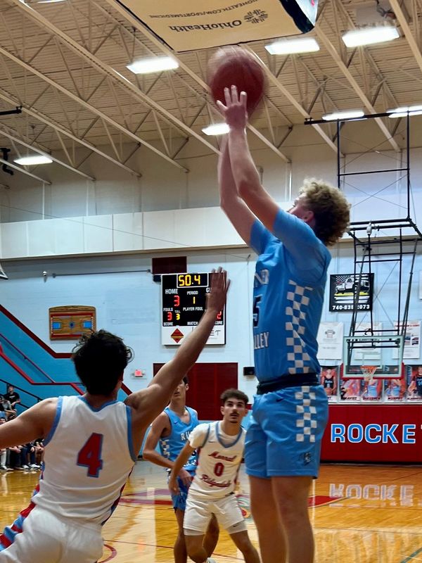 River Valley's Chase Smith shoots over the defense of Ridgedale's Isaac Lust during a boys basketball season opener for both teams Nov. 26, 2025 at Ridgedale.