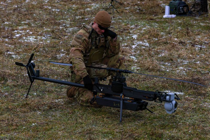 A U.S. soldier assigned to the 3rd Brigade, 10th Mountain Division, prepares the Anduril Ghost-X Medium-Range Reconnaissance (MRR) drone for flight during exercise Combined Resolve 25-1 at the Joint Multinational Readiness Centre, Hohenfels Training Area, Hohenfels, Germany, Jan. 15, 2025. U.S. Army/Sgt. Chandler Coats