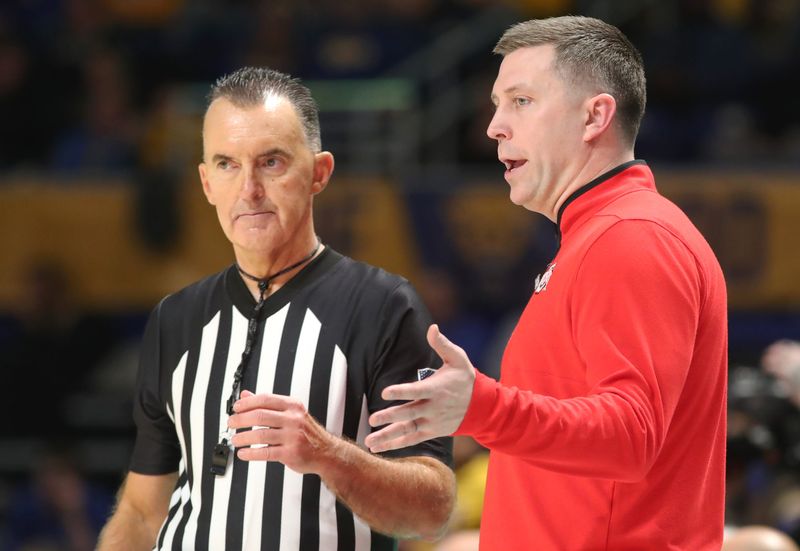 Nov 28, 2025; Pittsburgh, Pennsylvania, USA; Ohio State Buckeyes head coach Jake Diebler (right) talks with referee Roger Ayers (left) during the first half against the Pittsburgh Panthers at the Petersen Events Center. Mandatory Credit: Charles LeClaire-Imagn Images
