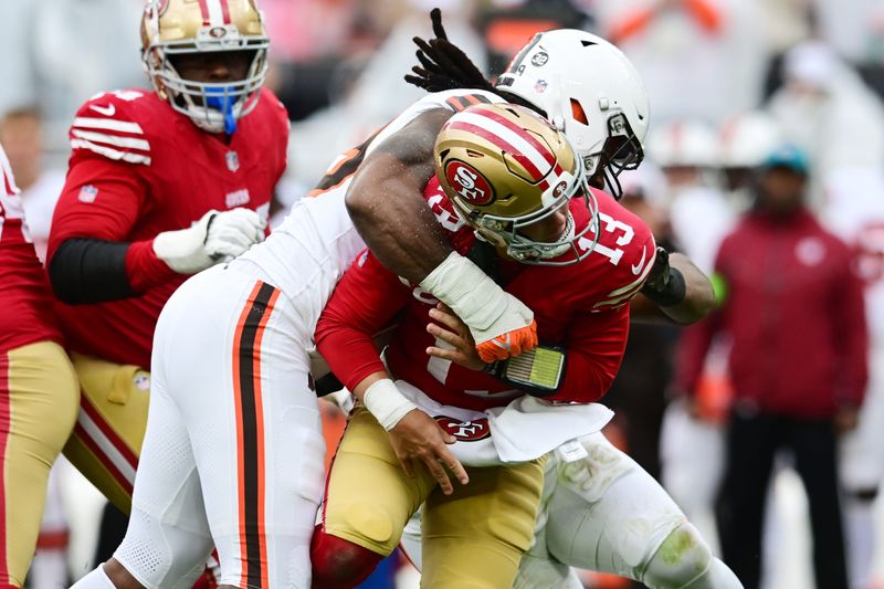 Oct 15, 2023; Cleveland, Ohio, USA; Cleveland Browns defensive end Za'Darius Smith (99) hits San Francisco 49ers quarterback Brock Purdy (13) after a pass during the first half at Cleveland Browns Stadium. Mandatory Credit: Ken Blaze-USA TODAY Sports