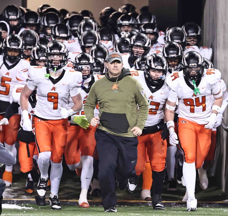 Anderson head coach Evan Dreyer leads his team on the field before their OHSAA Division II state championship game in Canton, Ohio, Thursday, Dec. 4, 2025.