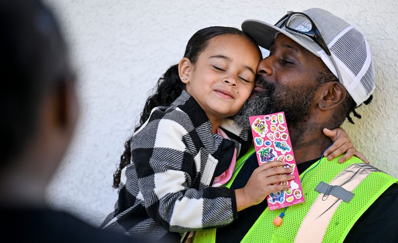 Kindergartener Alayah Richardson, 5, gives her father Cleo Richardson a big hug Thursday, August 14, 2025 before her first day of school at Washington Elementary.