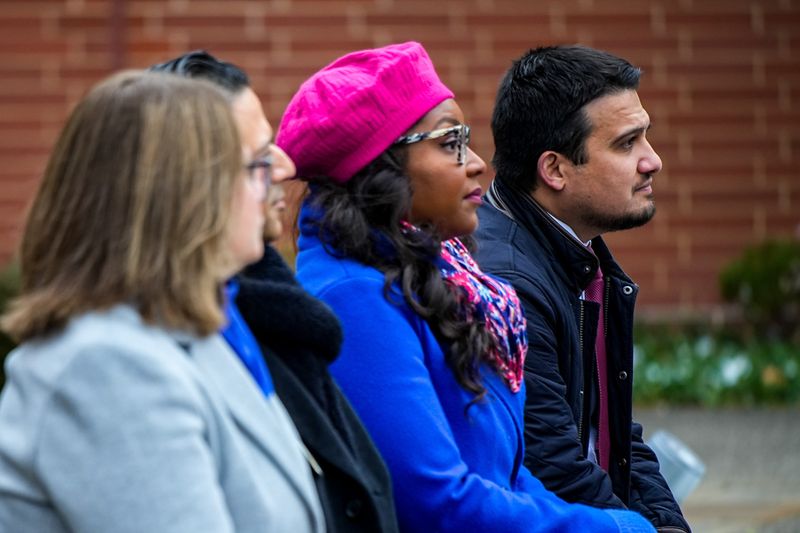 Mayor Shammas Malik, far right, along with U.S. Rep. Emilia Sykes, listens as Dave Lieberth, executive secretary of the Akron Bicentennial Commission, addresses attendees during the unveiling of Akron's new logo on Dec. 6, 2025, at 1 Perkins Square in Akron, Ohio.