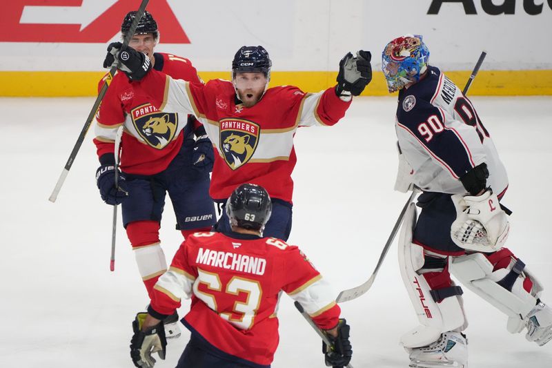 Panthers center Sam Bennett (9) celebrates the game-winning goal on Dec. 6 with left wing Brad Marchand (63) and center Evan Rodrigues (17) as Blue Jackets goaltender Elvis Merzlikins (90) leaves the ice.