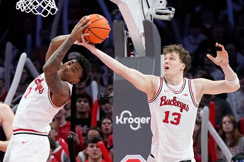 Ohio State Buckeyes center Christoph Tilly (13) and forward Amare Bynum (1) fight for a rebound during the second half of the NCAA men's basketball game against the Illinois Fighting Illini in Columbus on Dec. 9, 2025. Ohio State lost 86-78.